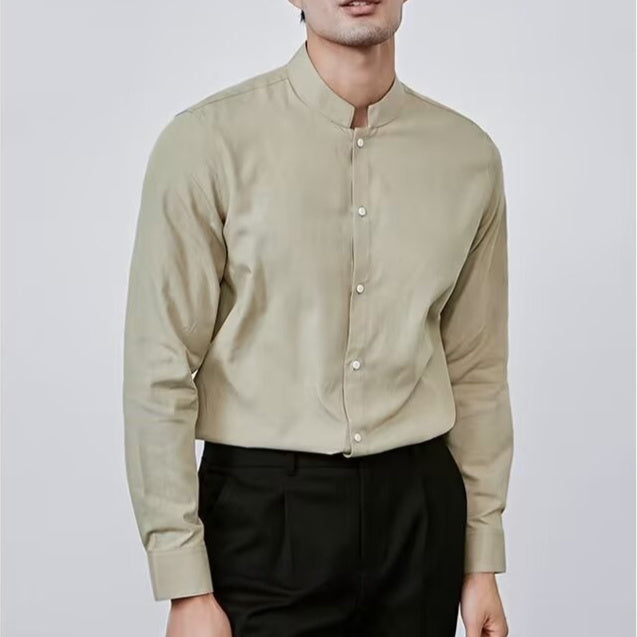Man wearing a beige long-sleeve shirt with a mandarin collar against a white background
