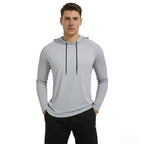 Man wearing a gray hoodie with black drawstrings on a white background