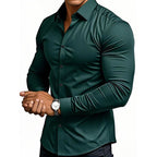 Person wearing a dark green shirt with a watch on a white background