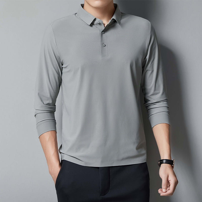 Person wearing a gray long-sleeve polo shirt against a gray background