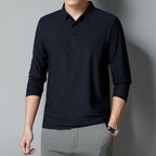 Person wearing a black long-sleeve polo shirt against a gray background