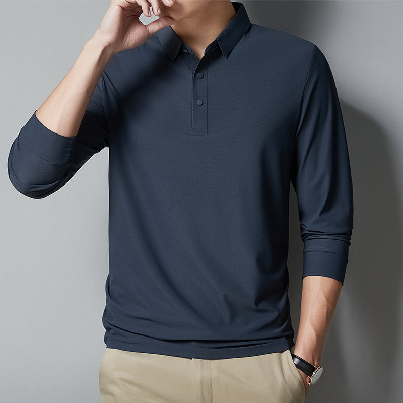 Man wearing a navy long-sleeve polo shirt against a gray background