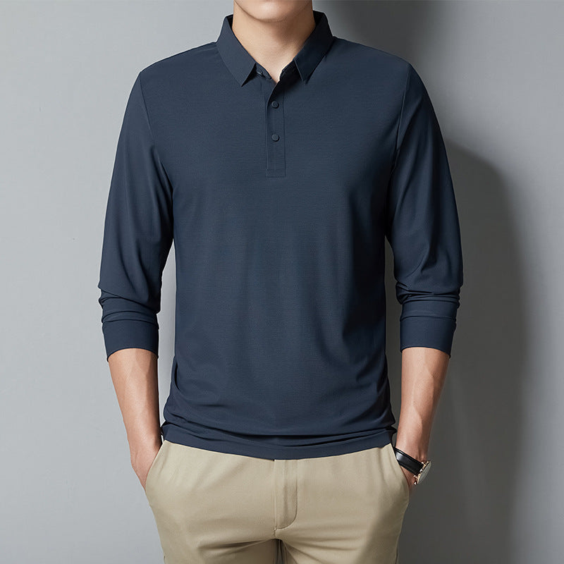 Person wearing a navy long-sleeve polo shirt against a gray background