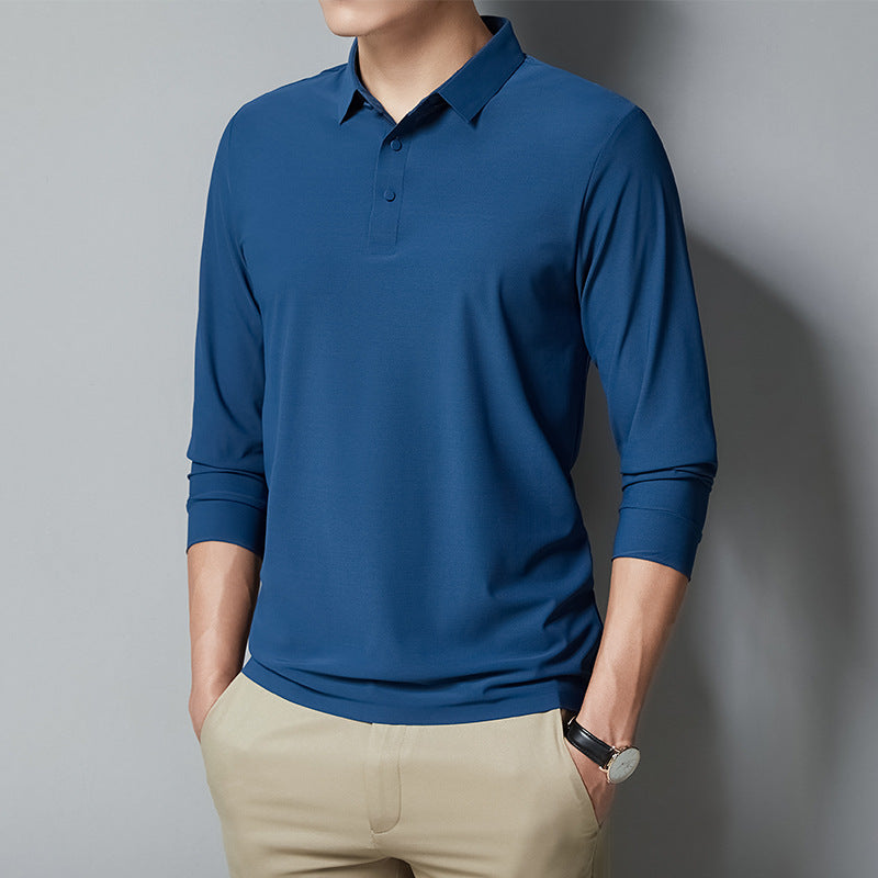 Person wearing a blue long-sleeve polo shirt against a gray background